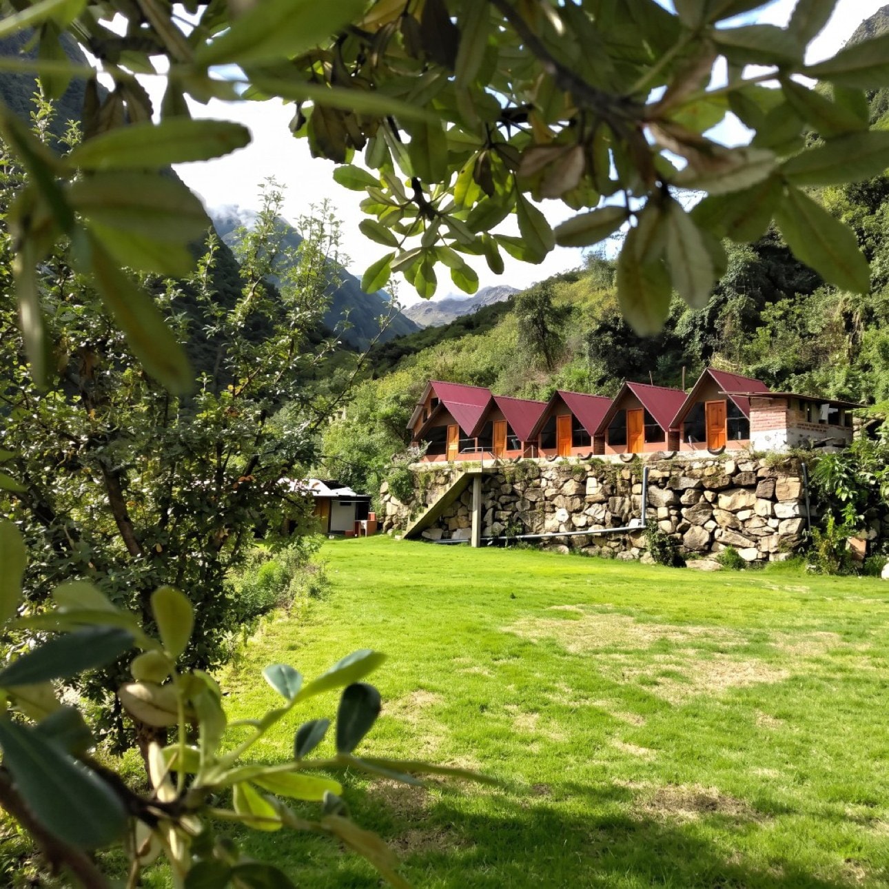 Wooden A-frame cabins at AndeStay Hostel in Colpapampa on the Salkantay Trek